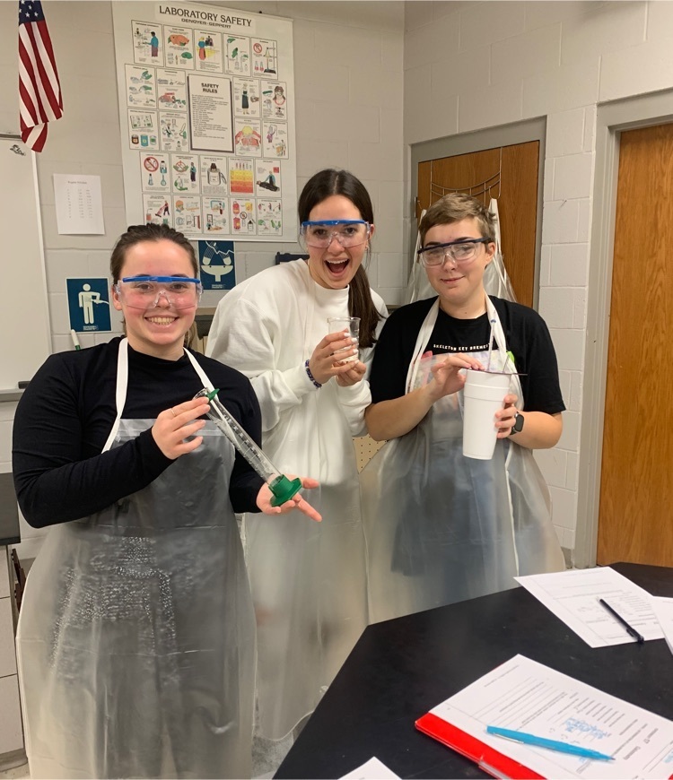 three chemistry students completing a calorimetry lab